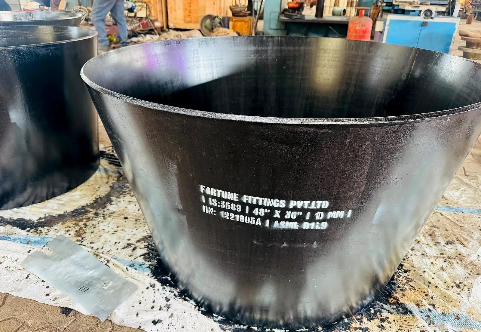 A large fabricated reducer with stencilled marking on its coated surface