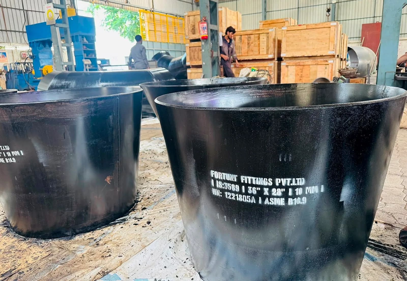 Two large fabricated reducers side by side in the works
